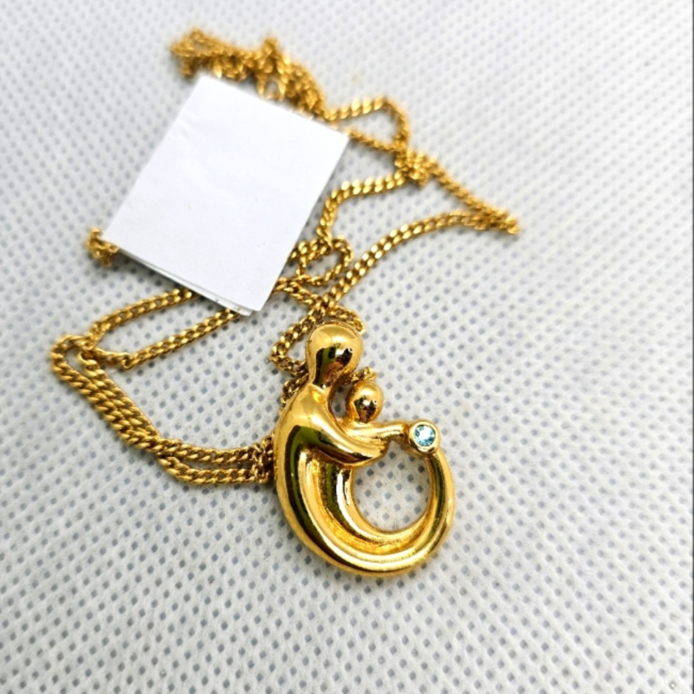 Goldtone Mother holding child with December Birthstone Fashion Necklace